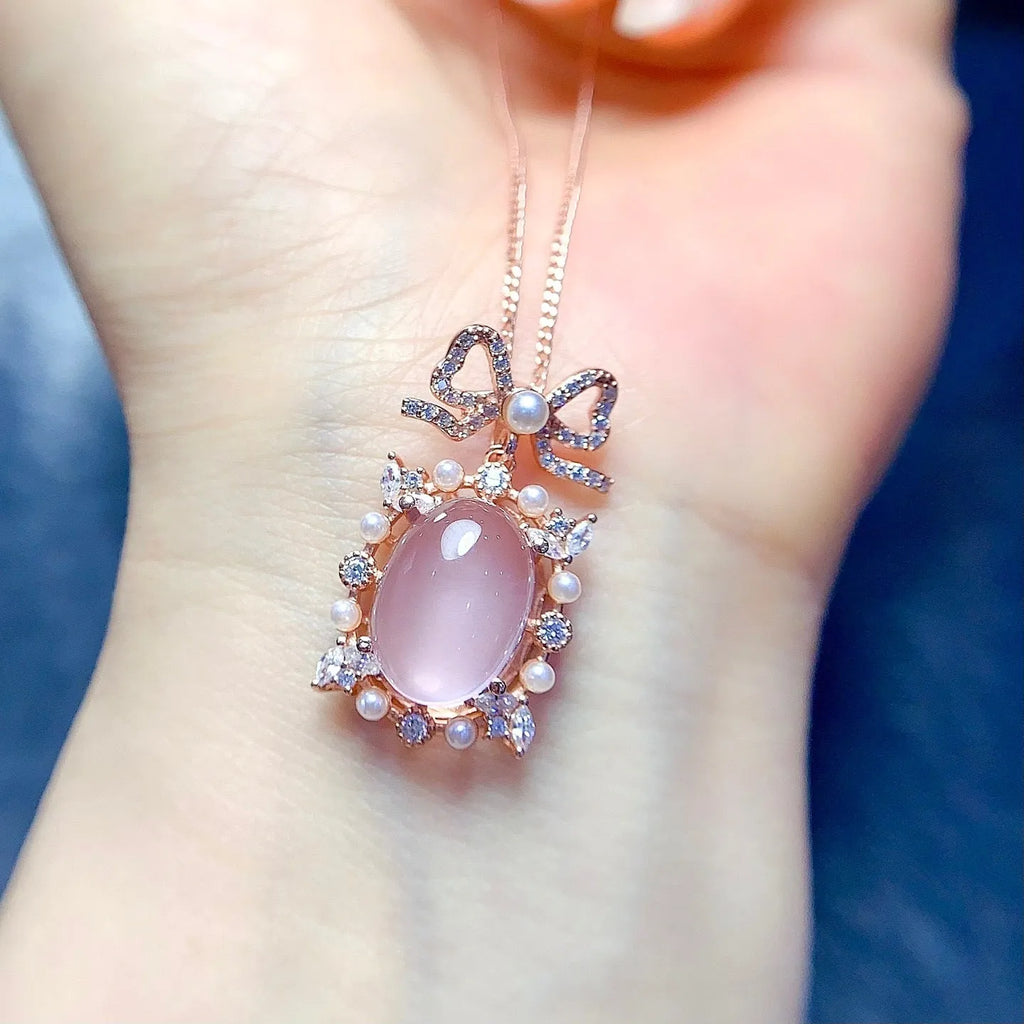 Pink rose quartz geometric pendant on a silver and rose gold plated necklace chain.