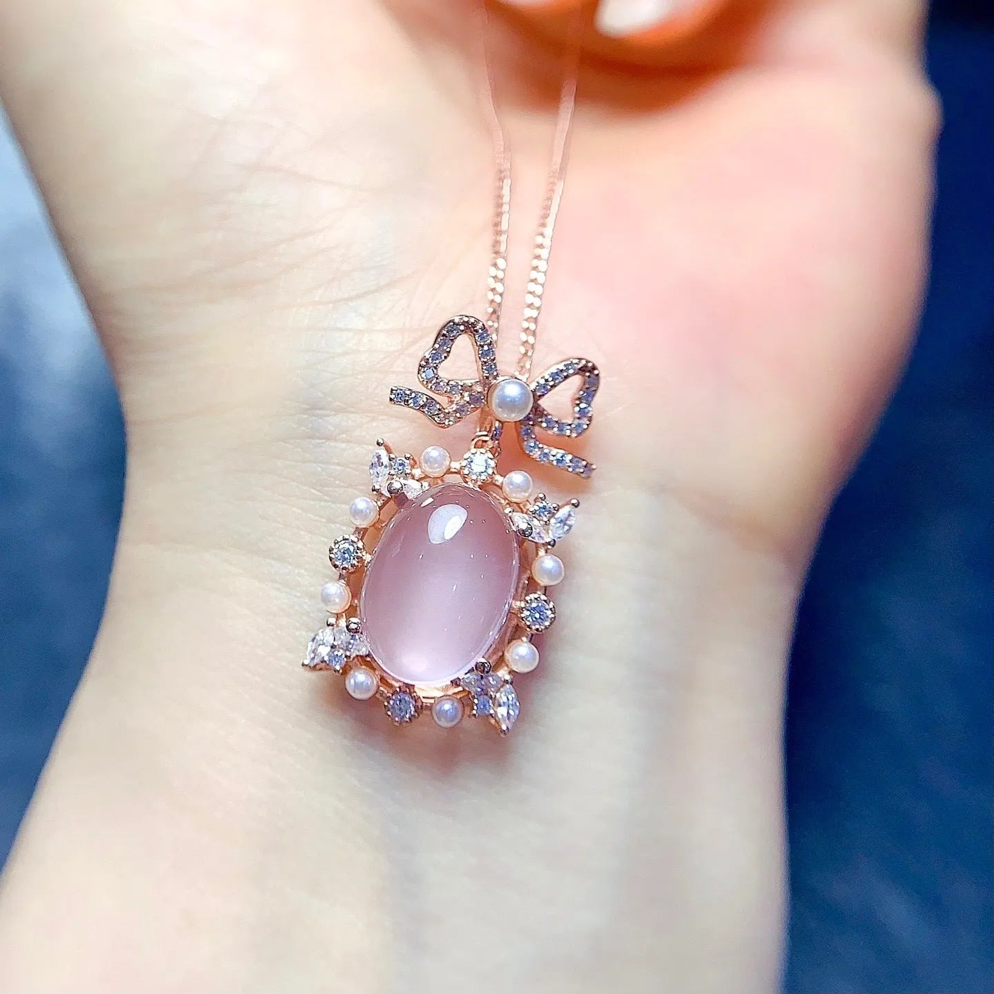 Pink rose quartz geometric pendant on a silver and rose gold plated necklace chain.