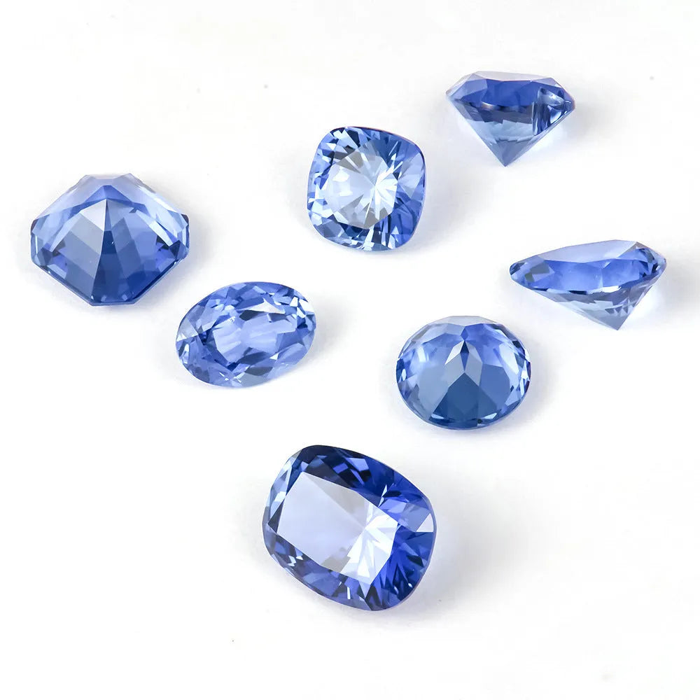 Royal blue cubic zirconia loose gemstone in a heart shape cut on a plain background.