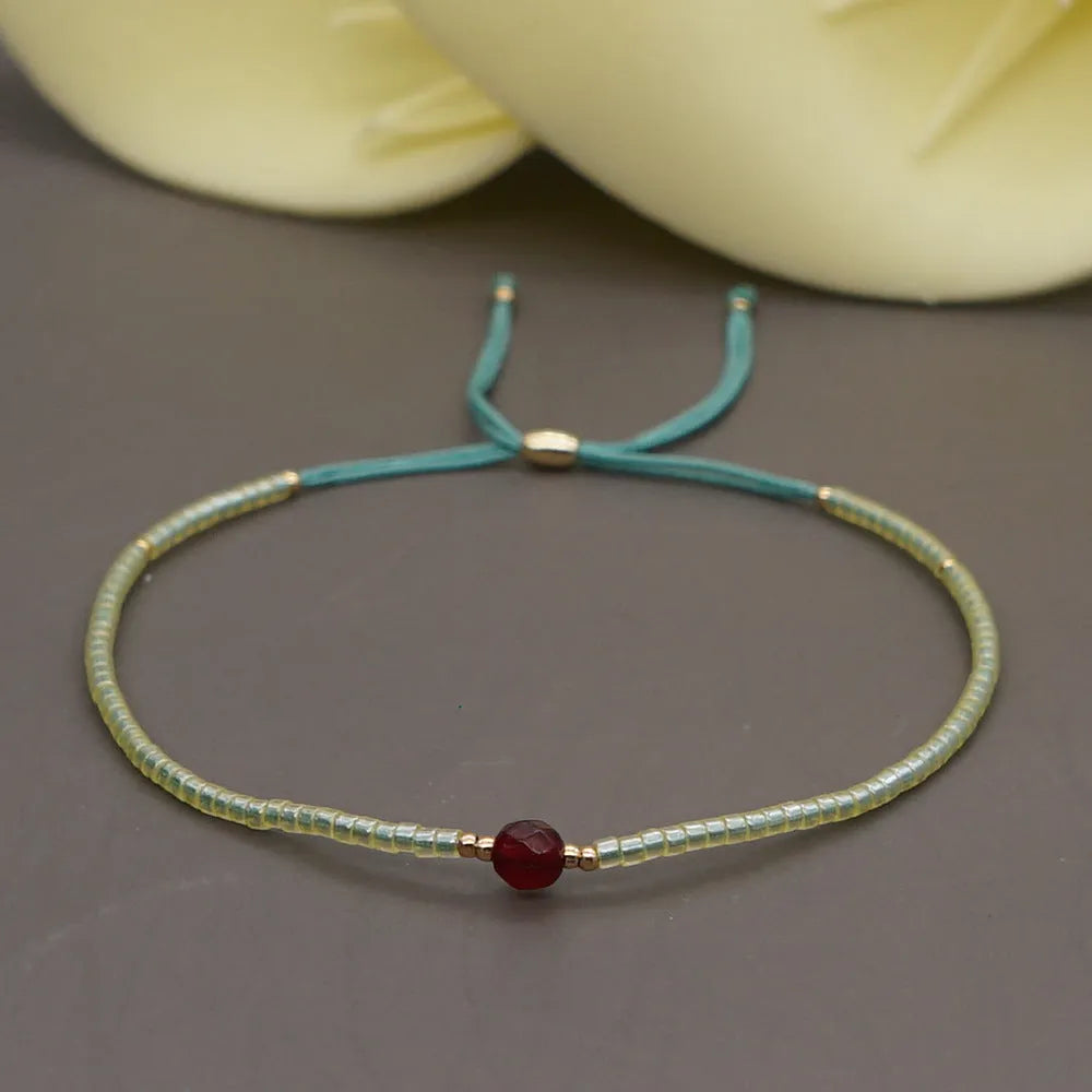 Handmade bohemian style bracelet with colourful geometric glass and coloured glaze beads.