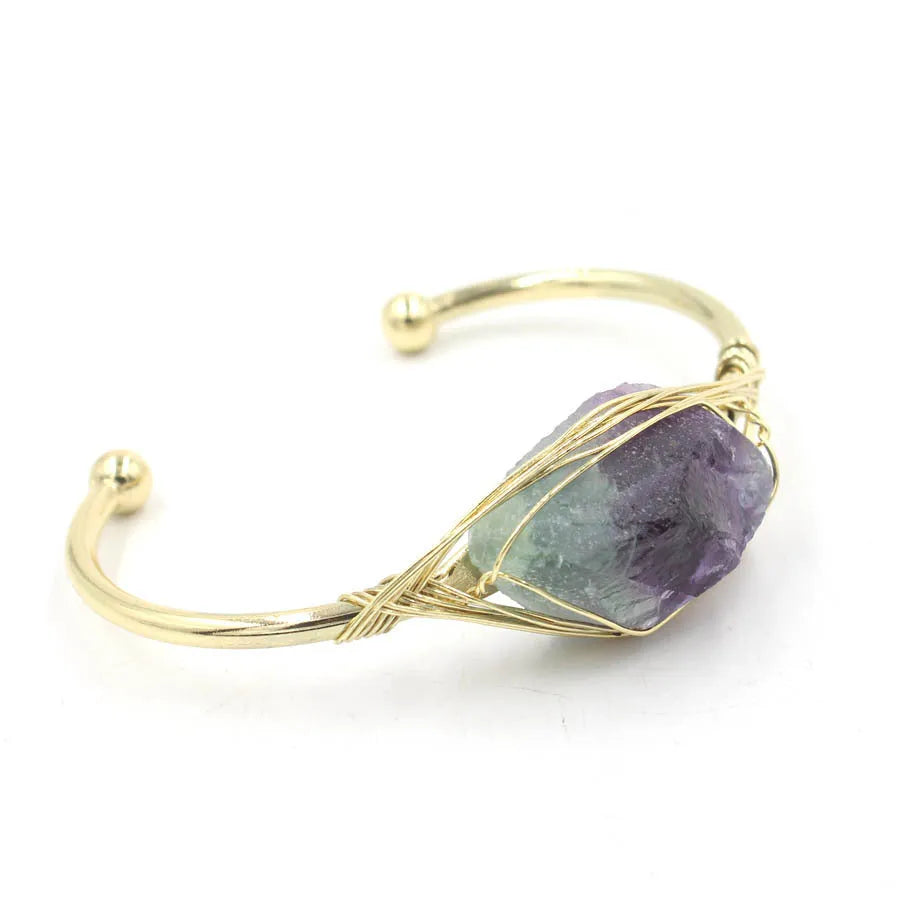 Natural raw gemstone winding bracelet with amethyst, pink crystal, and green fluorite stones on a string with a clasp.