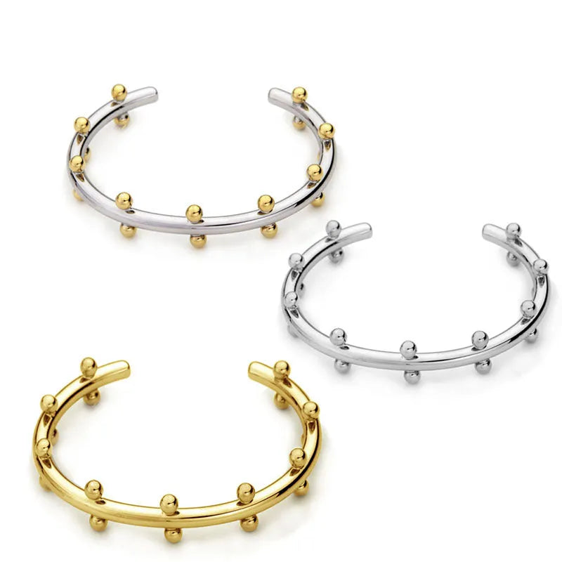 Stainless steel bracelet with textured bean beads and C-shaped adjustable closure