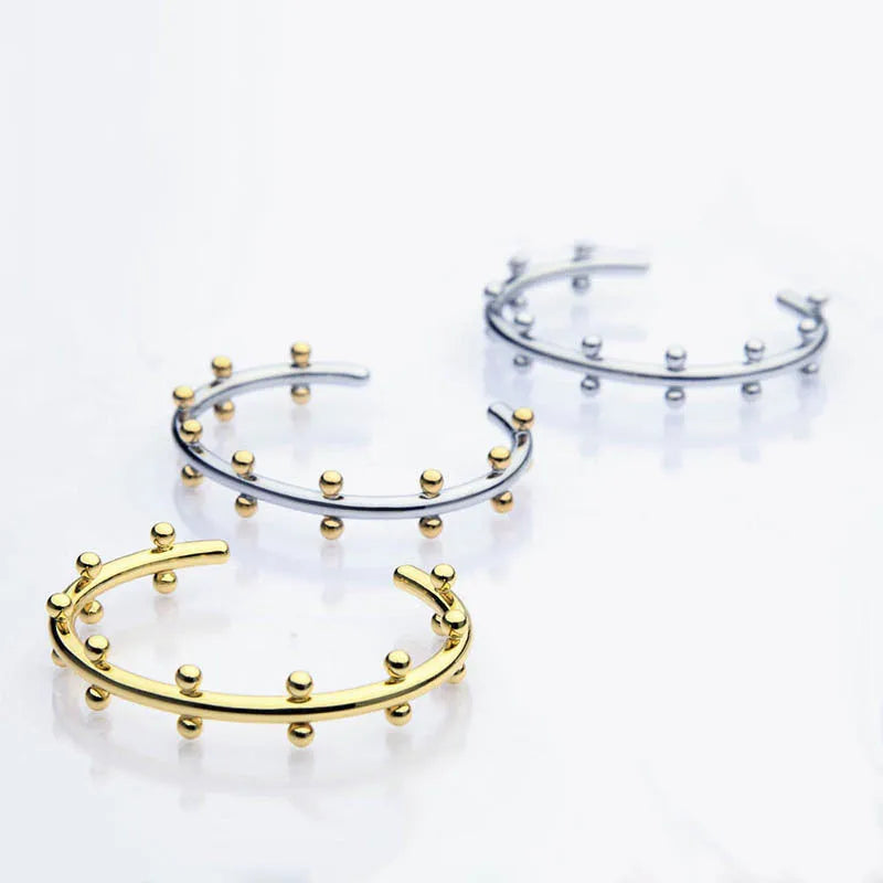 Stainless steel bracelet with textured bean beads and C-shaped adjustable closure
