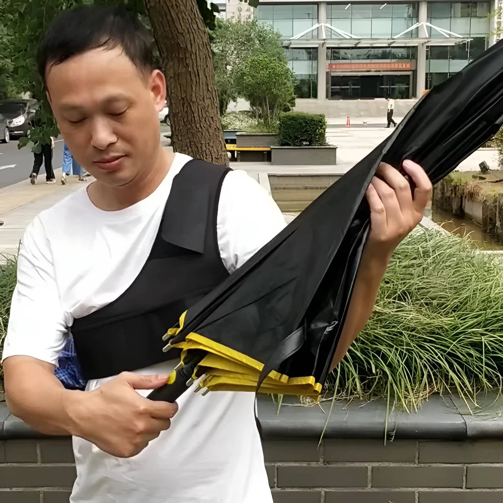 Black portable umbrella holder with shoulder strap showing diving cloth construction and adjustable fit
