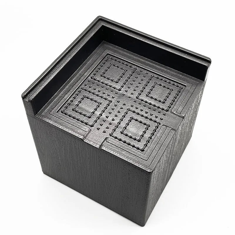 Set of four black thickened plastic bed foot mats for furniture height adjustment.