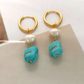 A pair of geometric turquoise and cultured pearl clip-on earrings on a copper setting.