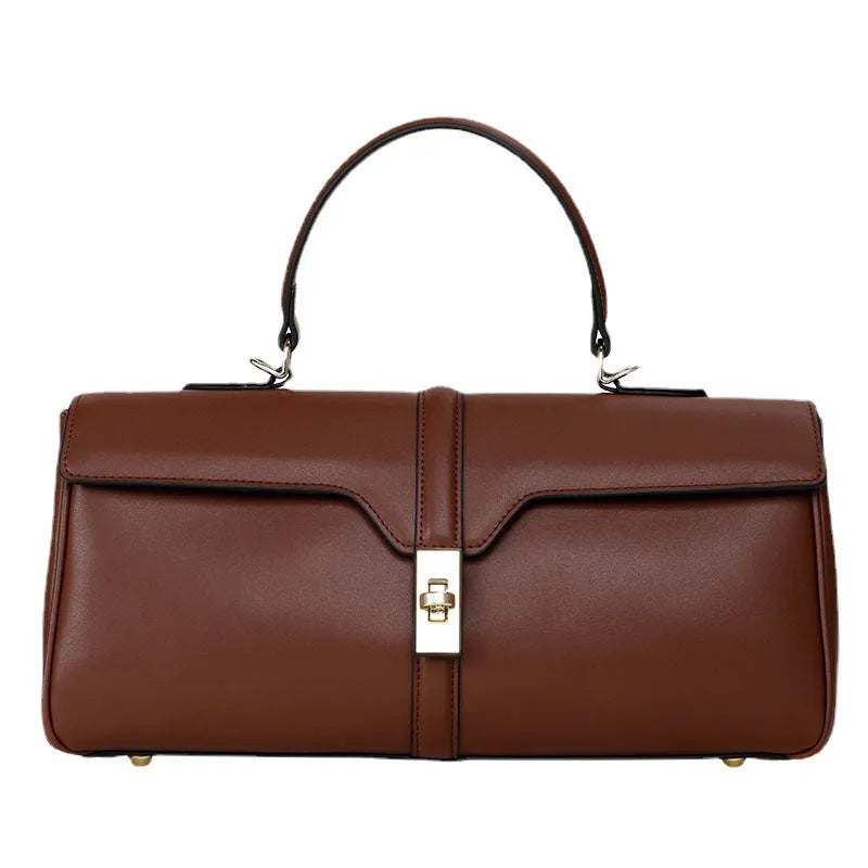 Women's solid colour cowhide leather messenger bag in black, cylindrical shape, with crossbody strap