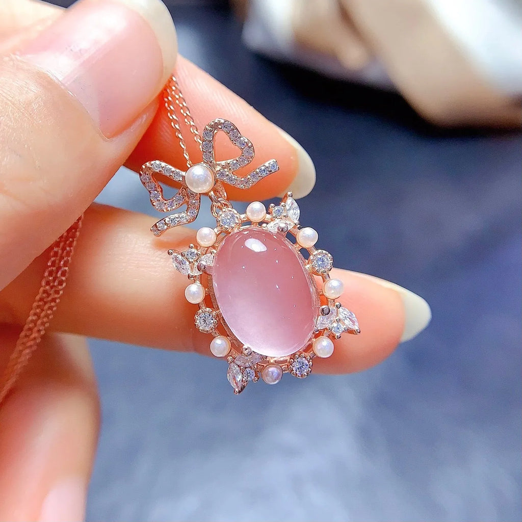 Pink rose quartz geometric pendant on a silver and rose gold plated necklace chain.