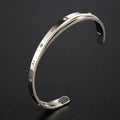 Open-ended stainless steel bracelet with inlaid zircon stones in rose gold colour