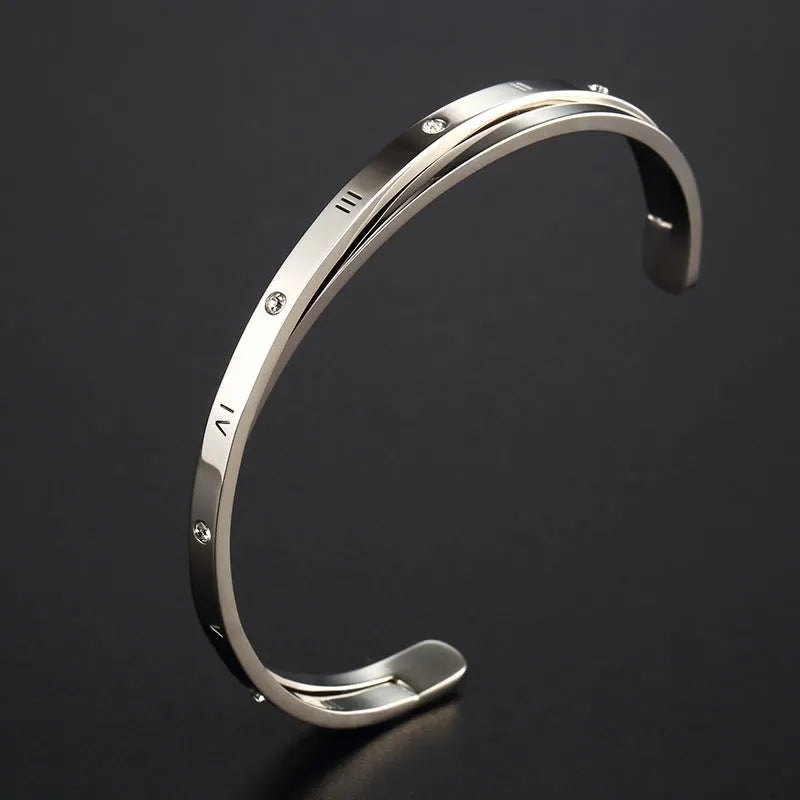 Open-ended stainless steel bracelet with inlaid zircon stones in rose gold colour