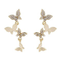 Women's copper butterfly drop earrings with gold finish showing four butterfly design