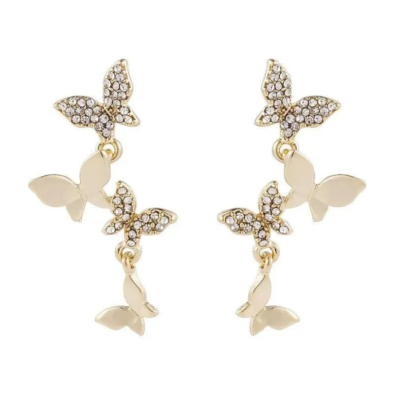 Women's copper butterfly drop earrings with gold finish showing four butterfly design