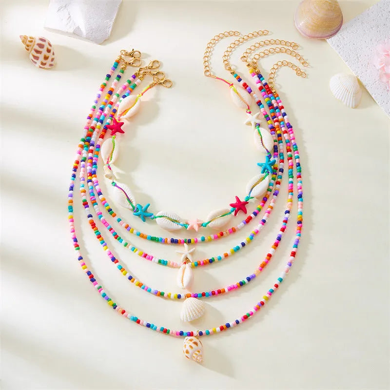 Five multi-layer shell bead necklaces with adjustable chains in blue and mixed colours