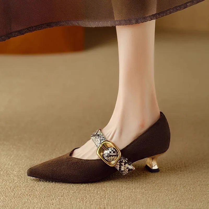 Black pointed toe women's stiletto heels with a buckle fastener on the side.