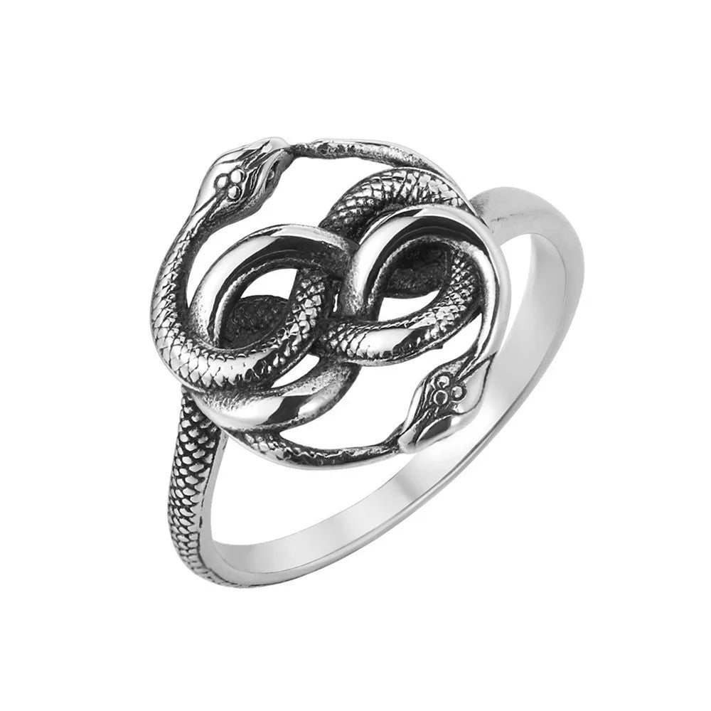 Close-up of a titanium steel double snake ring in a retro style on a grey background.