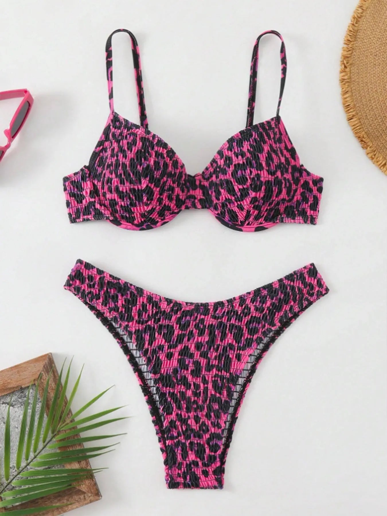 Women's leopard print bikini set with backless top and briefs bottom in brown and red colour options.