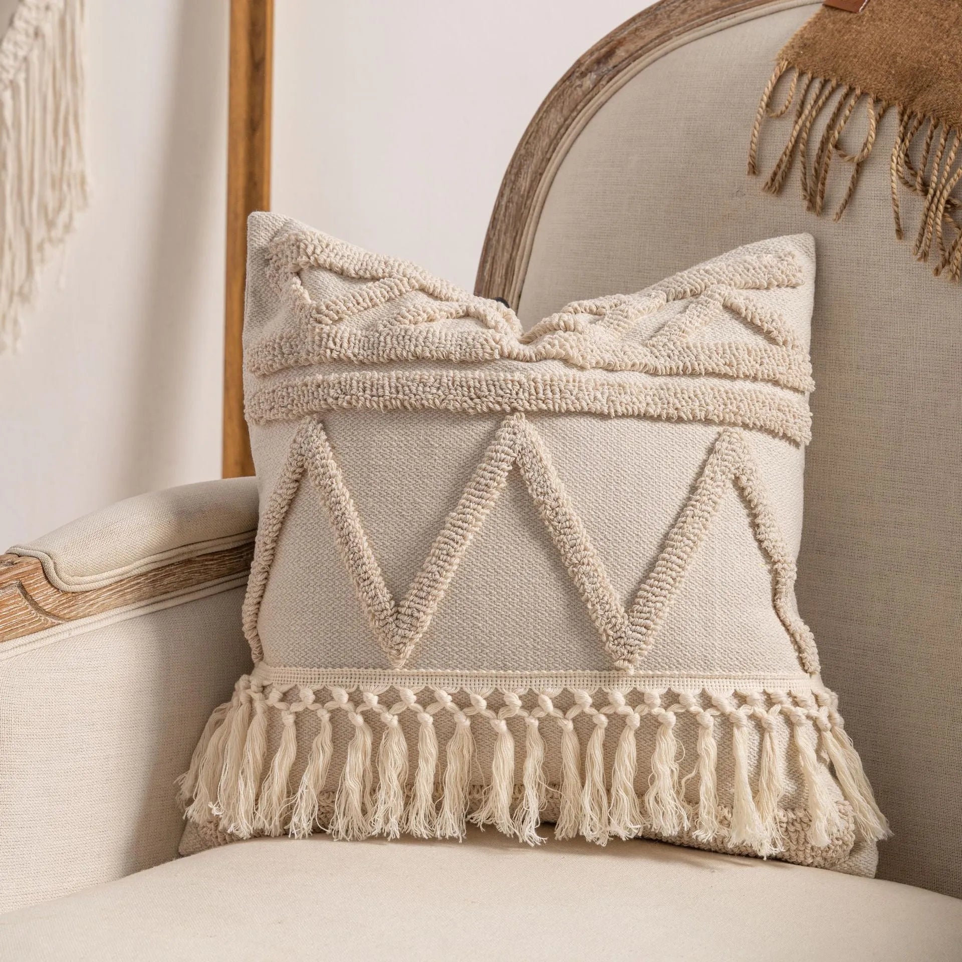 Knitted cushion cover with tassel trim in a printed spiral dots pattern, shown in 45x45cm size.
