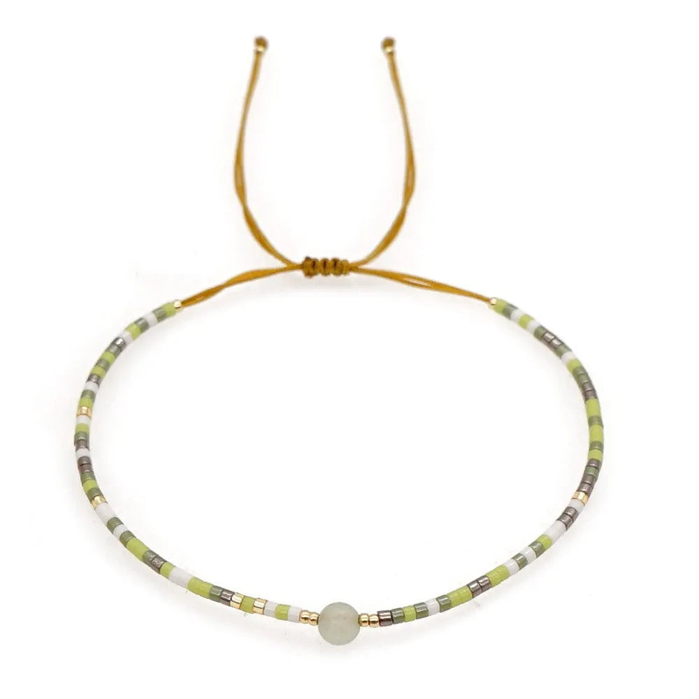 Handmade bohemian style bracelet with colourful geometric glass and coloured glaze beads.