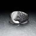 Silver geometric wolf head men's ring on a dark background, showing angular design details.