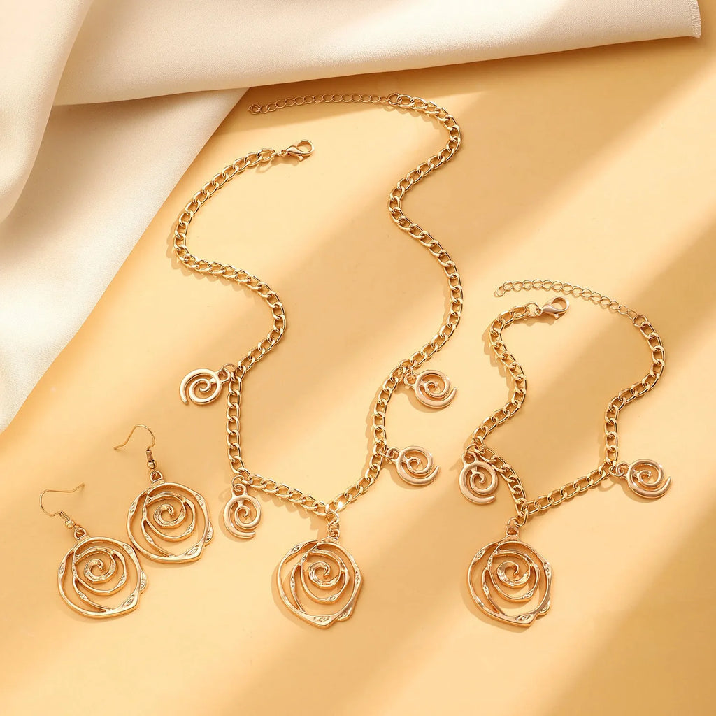 Women's spiral donut jewellery set showing necklace, bracelet and earrings in gold alloy finish