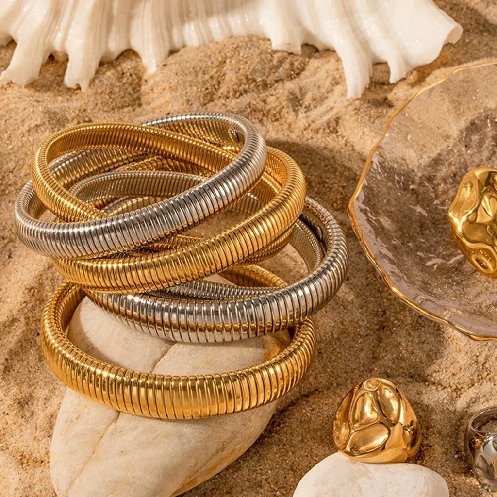 Gold titanium steel bracelet with elastic band and exaggerated vertical stripe ring design