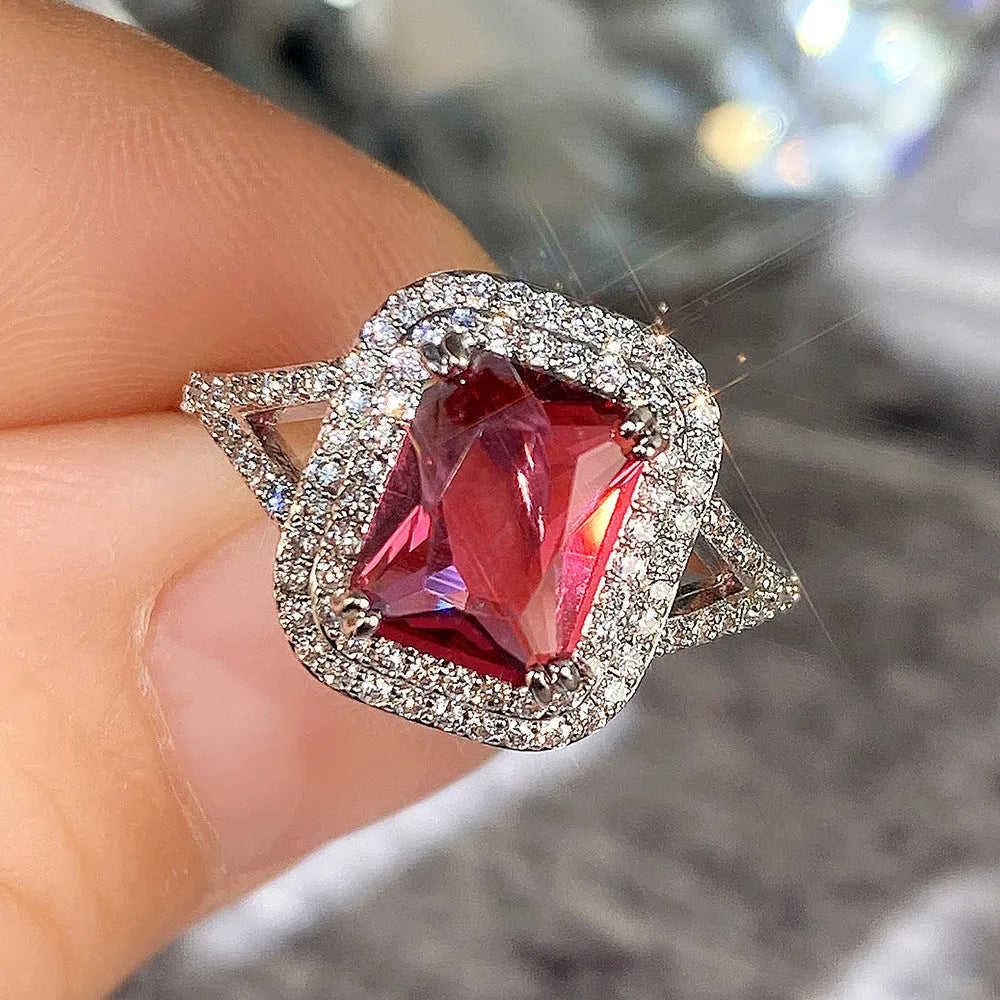 Women's geometric square copper ring with crystal rhinestones in red, showing princess design