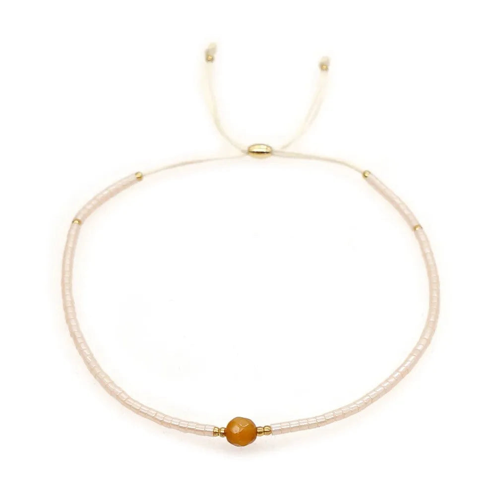 Handmade bohemian style bracelet with colourful geometric glass and coloured glaze beads.