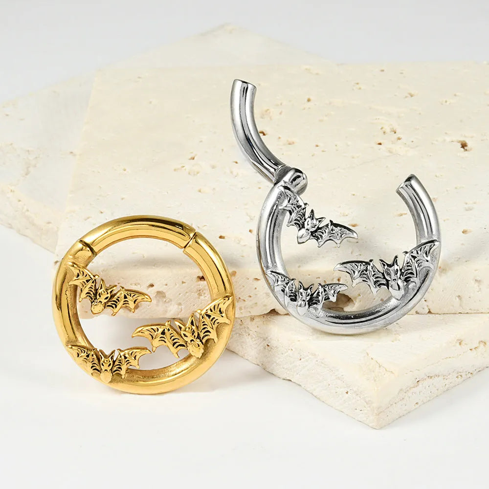 A pair of stainless steel fashion earrings featuring a geometric totem pattern with an electroplated coloured finish.