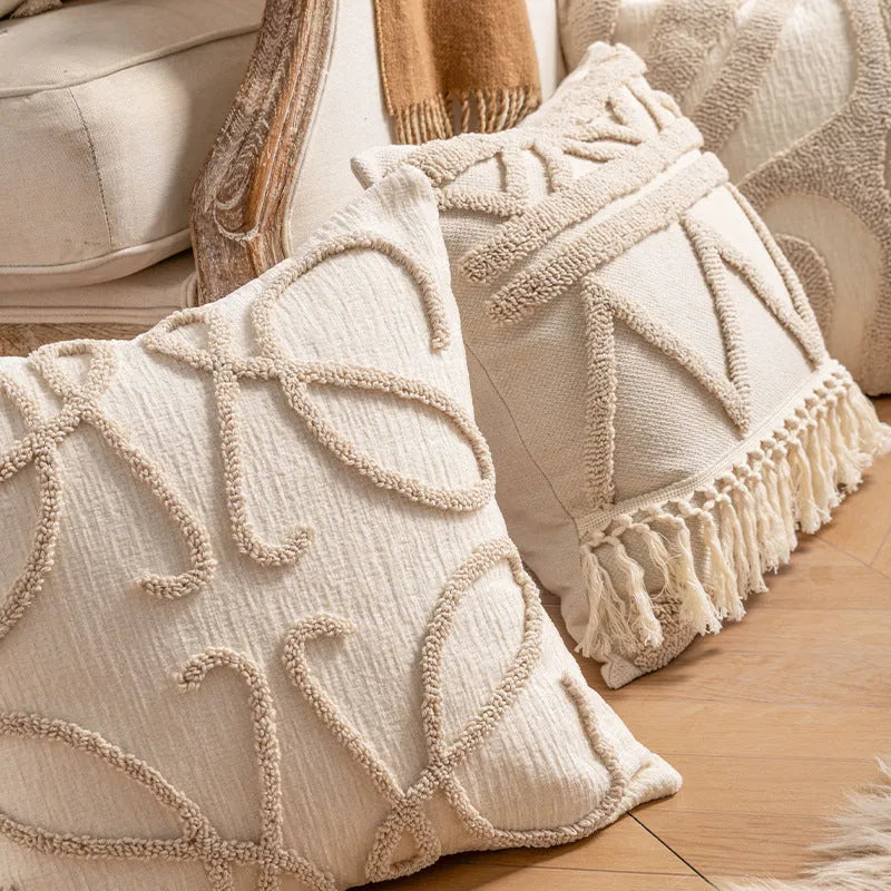Knitted cushion cover with tassel trim in a printed spiral dots pattern, shown in 45x45cm size.