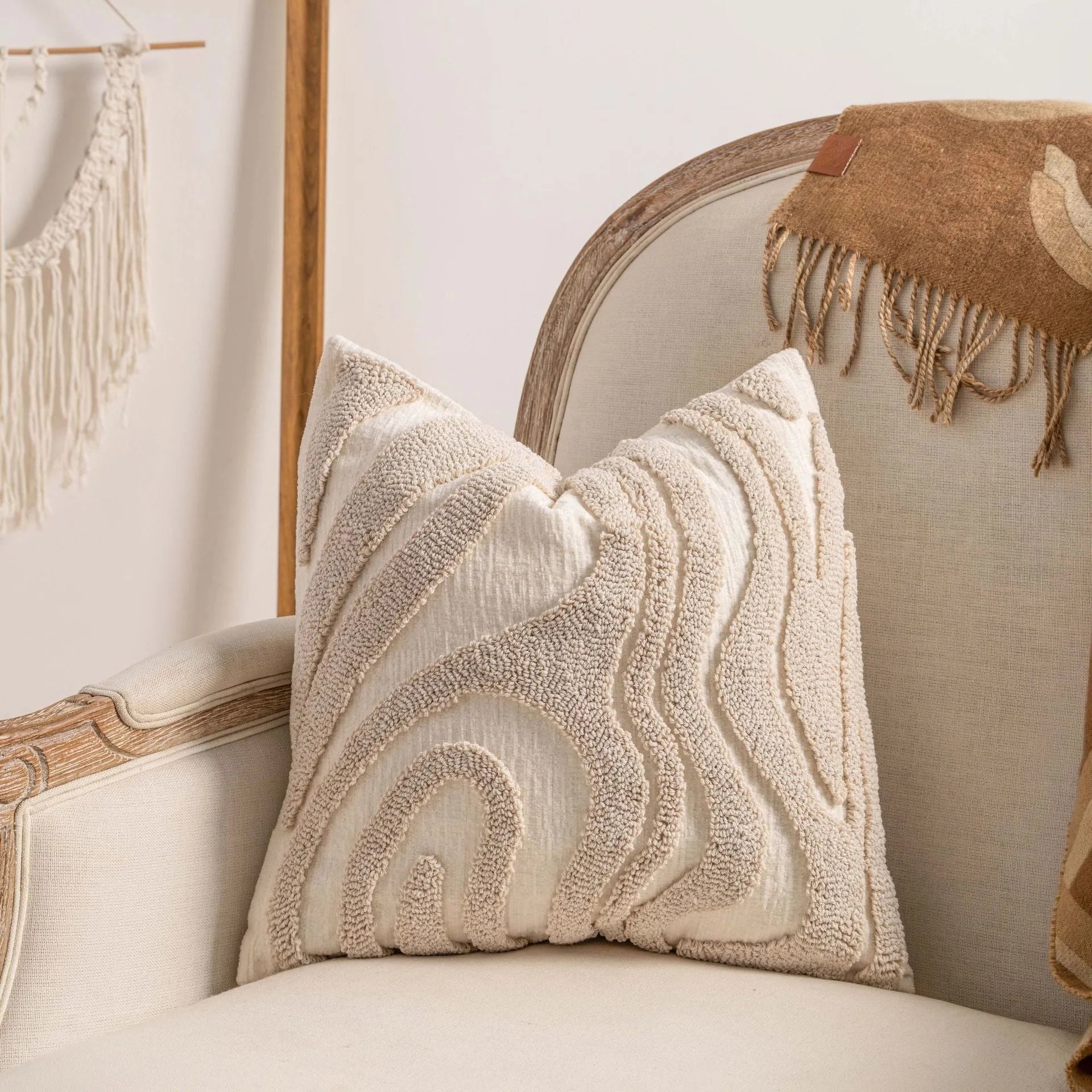 Knitted cushion cover with tassel trim in a printed spiral dots pattern, shown in 45x45cm size.