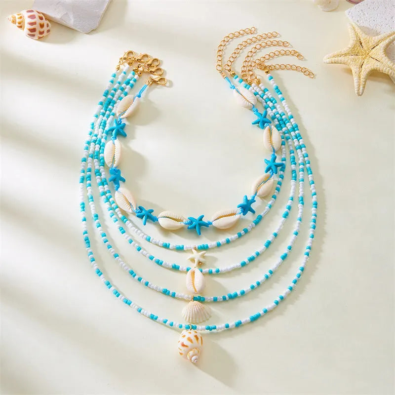 Five multi-layer shell bead necklaces with adjustable chains in blue and mixed colours