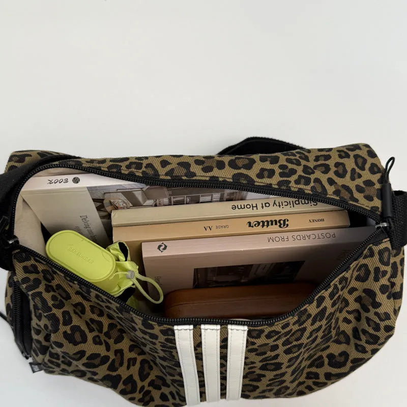 Sports style messenger bag in leopard print pattern with visible stitching and cross-body strap