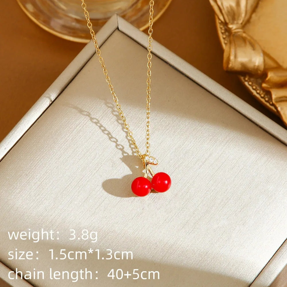 Titanium steel necklace with delicate fruit pendant on O-ring chain, available in golden and steel zircon finishes.