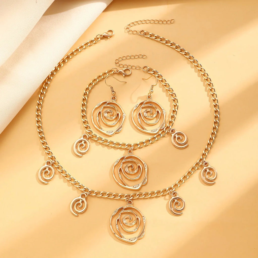 Women's spiral donut jewellery set showing necklace, bracelet and earrings in gold alloy finish