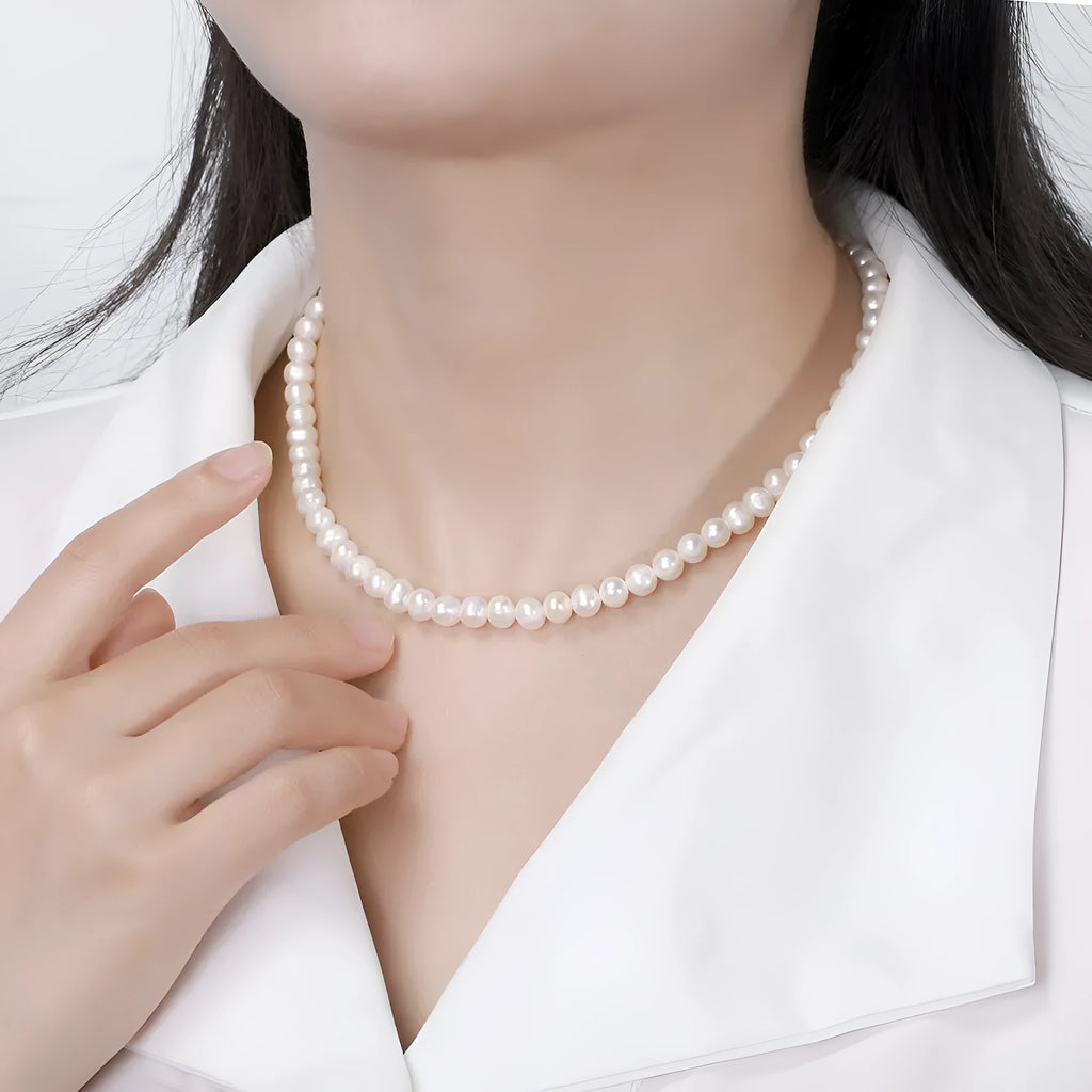 Women's adjustable silver necklace featuring a single round 6-7mm freshwater pearl on a chain.