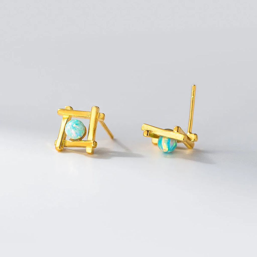 Geometric cross-shaped silver stud earrings for women on a white background.