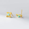 Geometric cross-shaped silver stud earrings for women on a white background.