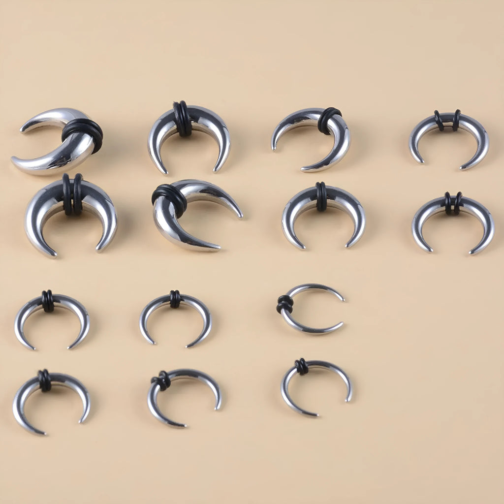 A black and steel coloured C-shaped geometric nose ring made from titanium steel and buffalo horn.