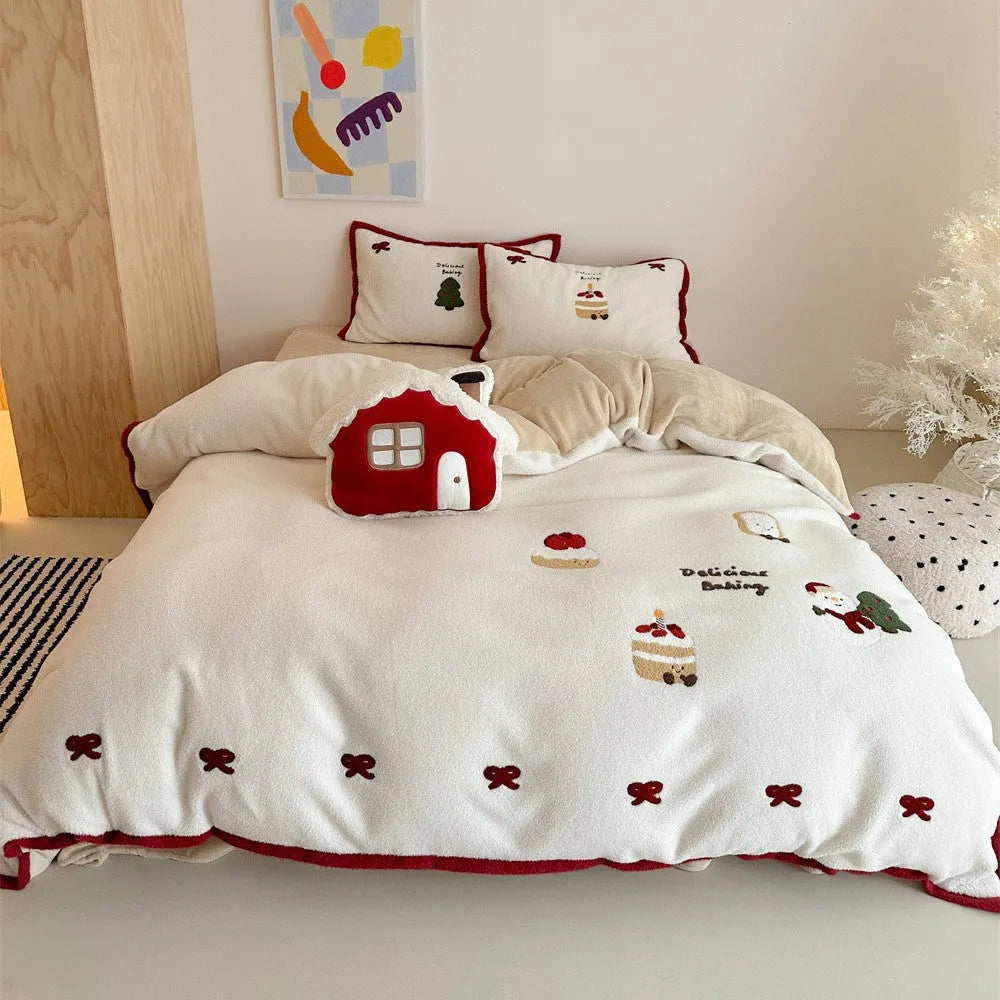 Girl's cartoon winter Christmas themed bedding four-piece set with duvet cover, sheet and pillowcases on a bed.