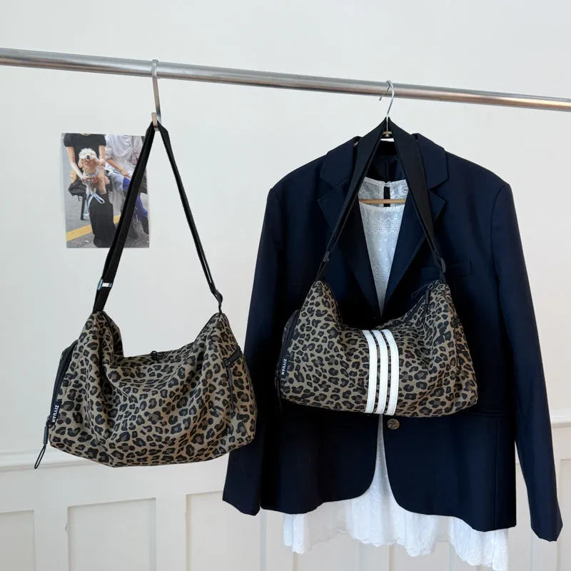 Sports style messenger bag in leopard print pattern with visible stitching and cross-body strap