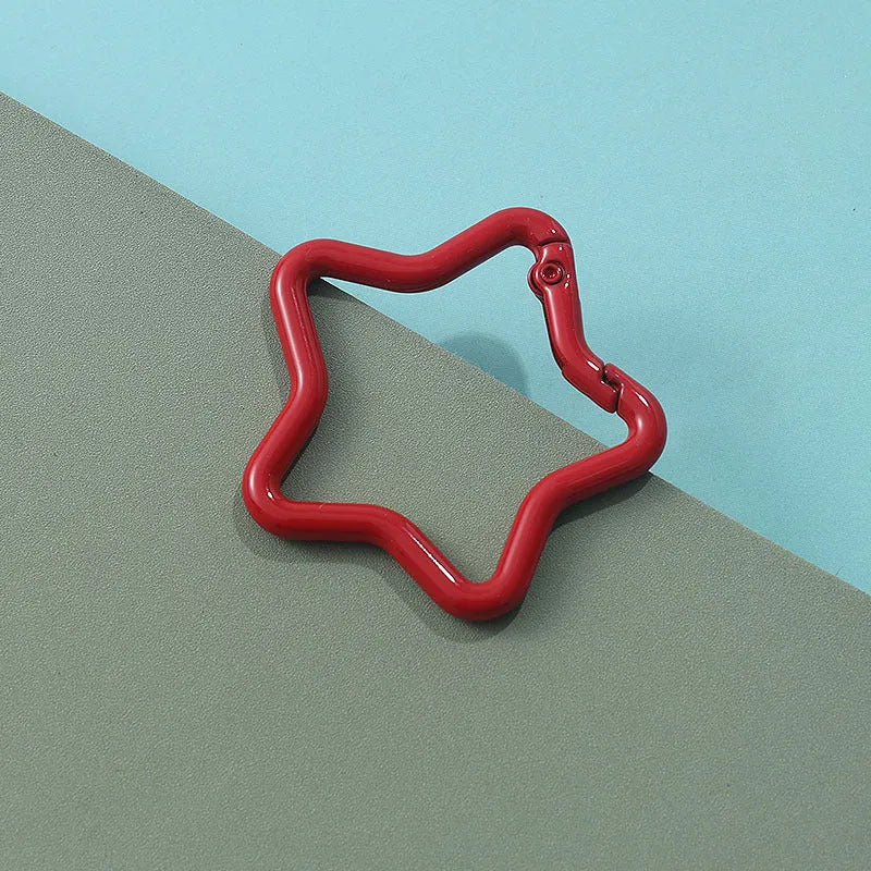 Zinc alloy five-pointed star keychain in light pink, one of ten available macaron colours.