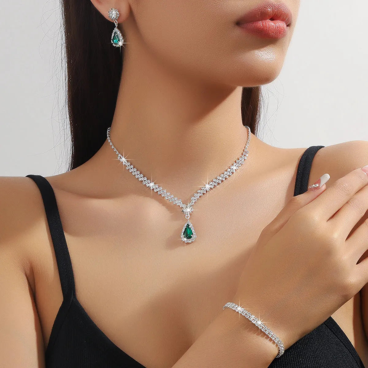 Claw chain necklace and matching drop earrings set with rhinestones in multiple colours.