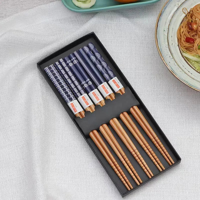 Set of five pairs of bamboo chopsticks with Japanese cartoon patterns in a gift box.
