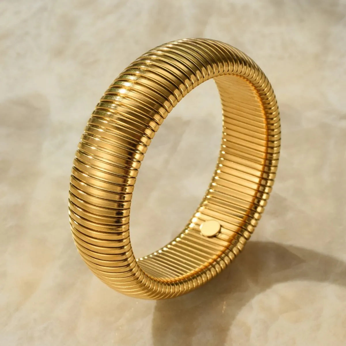 Gold titanium steel bracelet with elastic band and exaggerated vertical stripe ring design