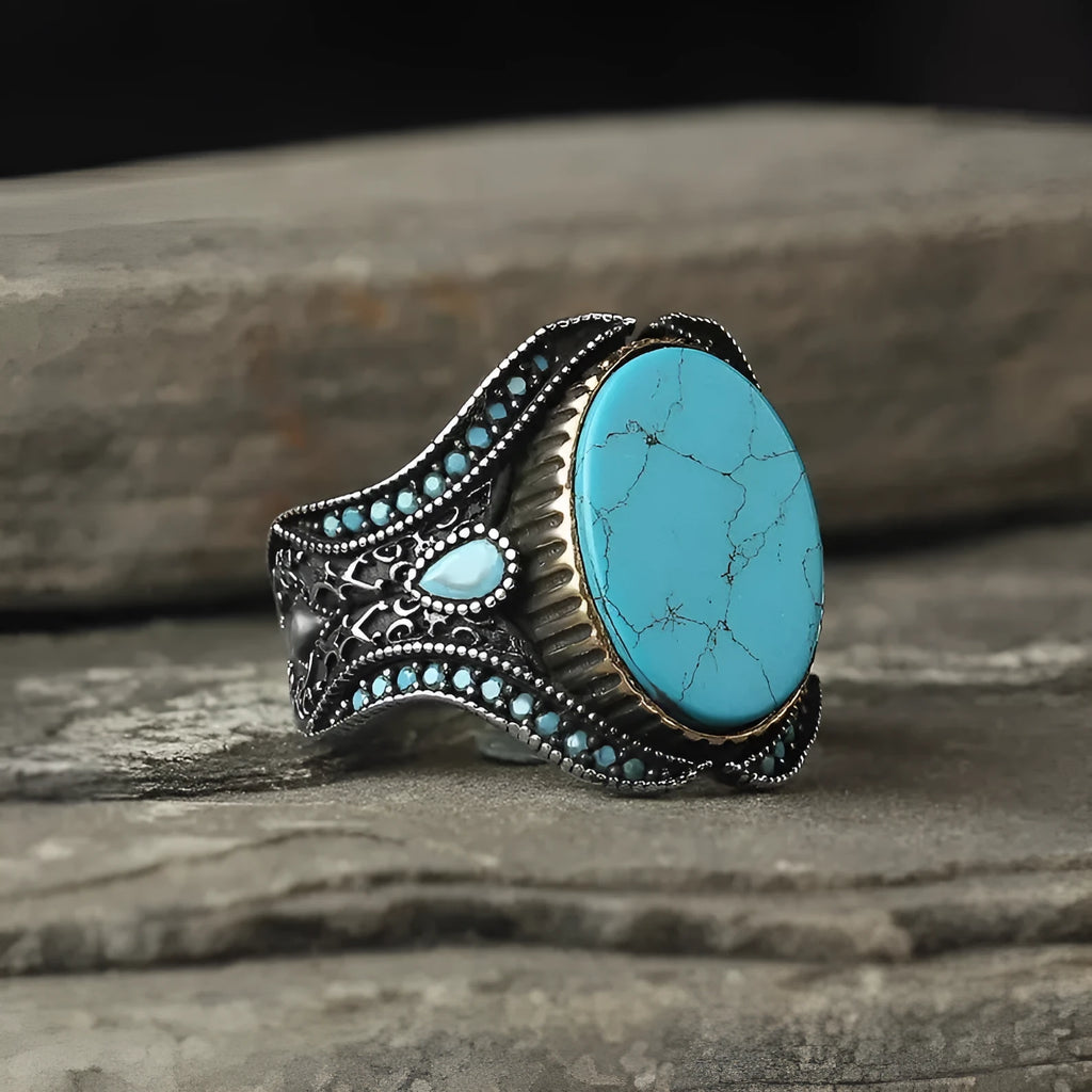Round turquoise men's ring with antique silver alloy band showing stone detail and metallic finish