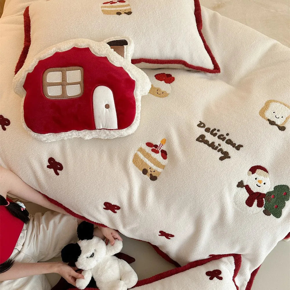 Girl's cartoon winter Christmas themed bedding four-piece set with duvet cover, sheet and pillowcases on a bed.