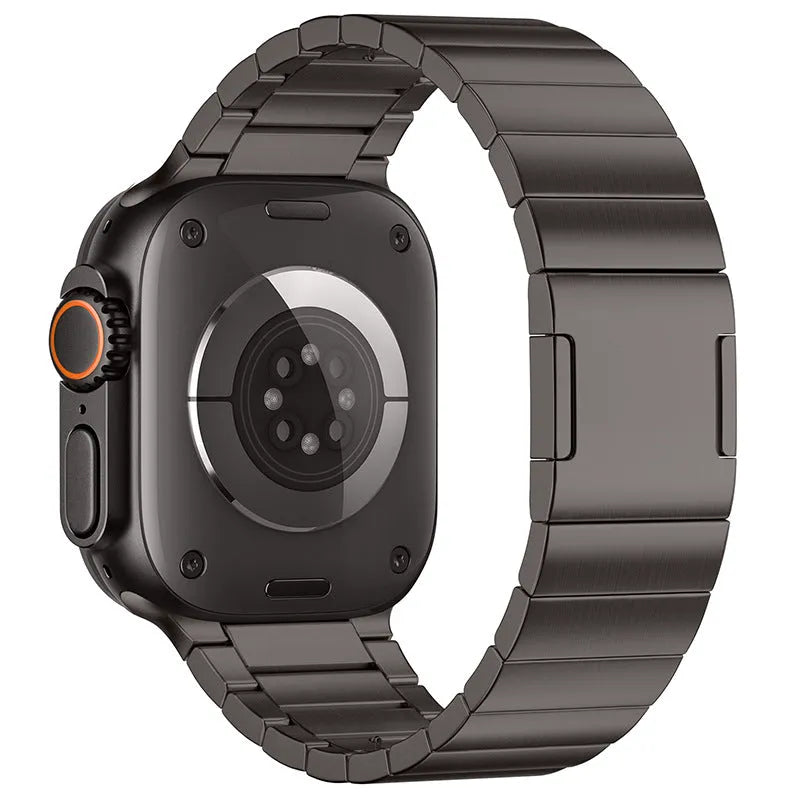 Silver stainless steel Apple Watch strap with magnetic buckle on a wrist, showing business style design.