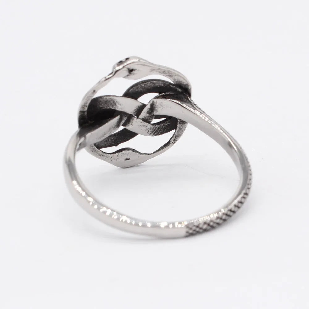 Close-up of a titanium steel double snake ring in a retro style on a grey background.