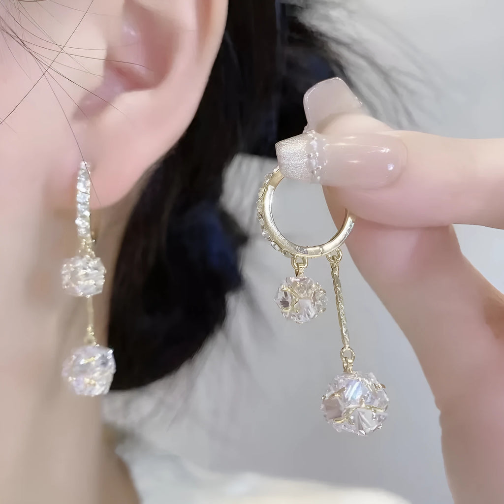 Silver coloured women's earrings with tassel ball and rhinestone ball pendants on ear clips