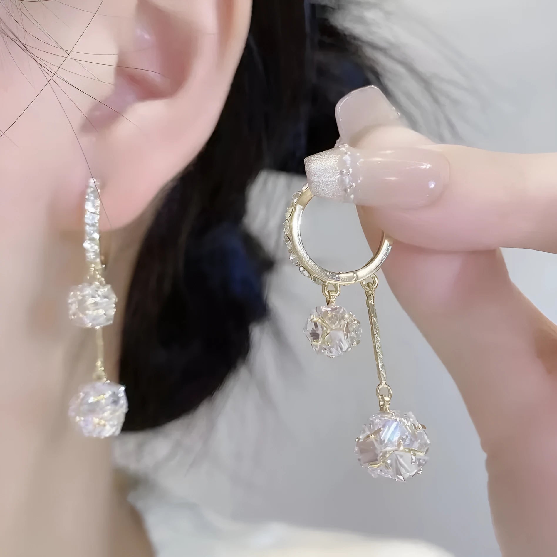 Silver coloured women's earrings with tassel ball and rhinestone ball pendants on ear clips
